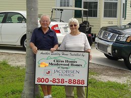 Happy couple in front of their new home