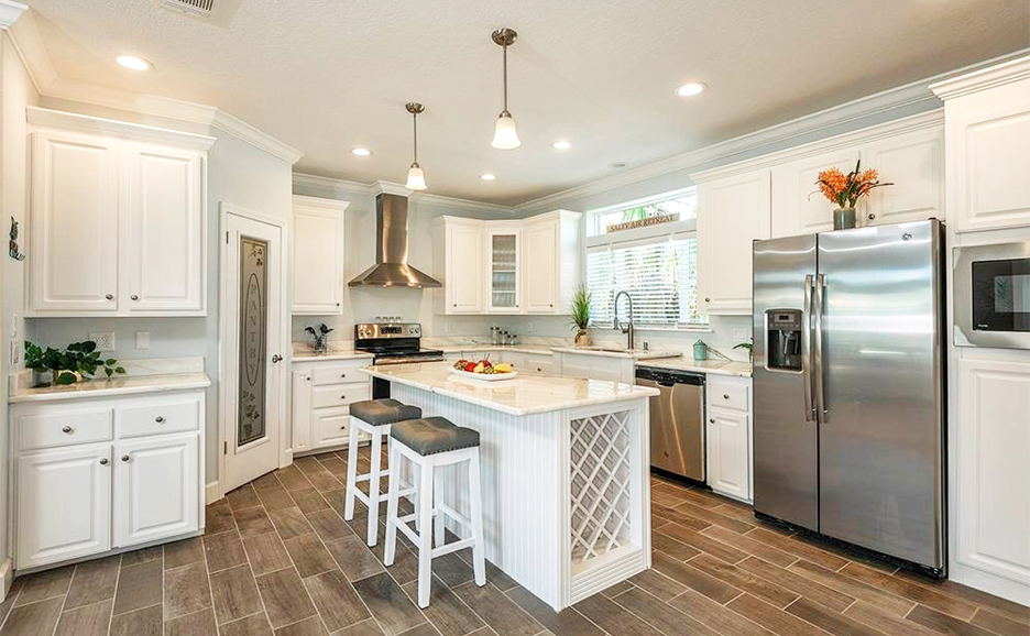 Kitchen with White Cabinets, Stainless Steel appliances, and a walk in Pantry