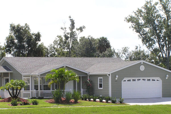 Photo of a triple wide home with a site built garage, front and side entry porches