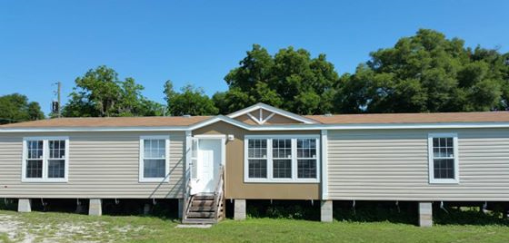 Exterior photo of a home with a dormer and lots of windows