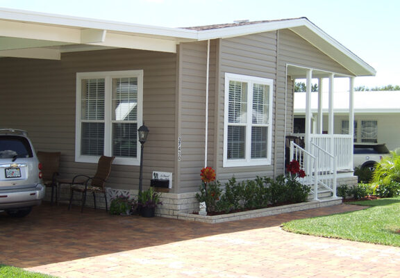 Exterior of home with entry porch and carport