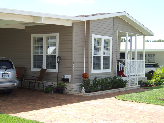 Exterior of home with entry porch and carport