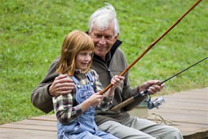 Grandpa and grand daughter fishing off the dock